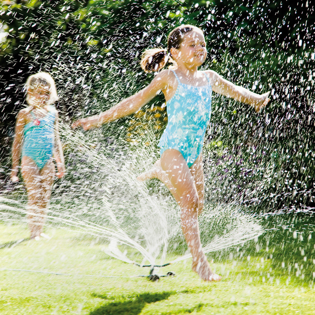 Children Playing in a Sprinkler